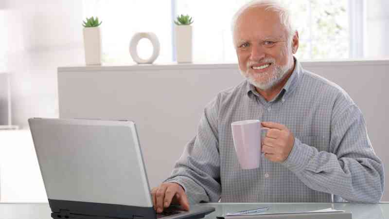 man sitting at computer presumably gambling online